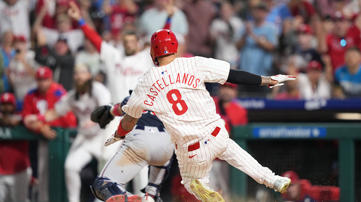 Philadelphia Phillies outfielder Nick Castellanos (8) slides home to score against the Atlanta Braves in the tenth inning at Citizens Bank Park.
