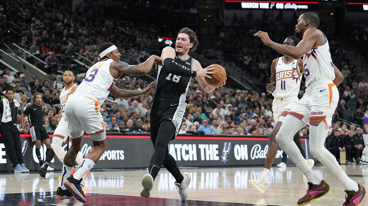 San Antonio Spurs forward Cedi Osman (16) drives in against Phoenix Suns guard Bradley Beal (3) in the first half at Frost Bank Center.