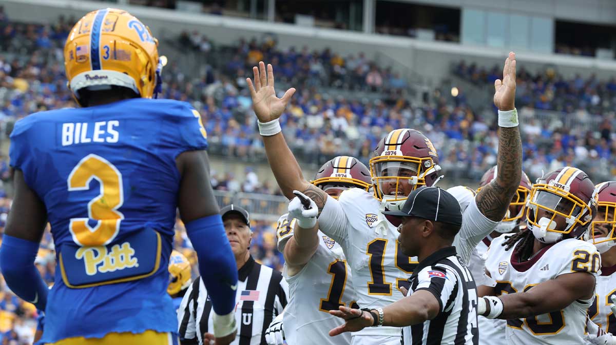Central Michigan Chippewas quarterback Jadyn Glasser (15) and teammates celebrate his touchdown against Pittsburgh Panthers linebacker Rasheem Biles (3) during the second quarter at Acrisure Stadium.