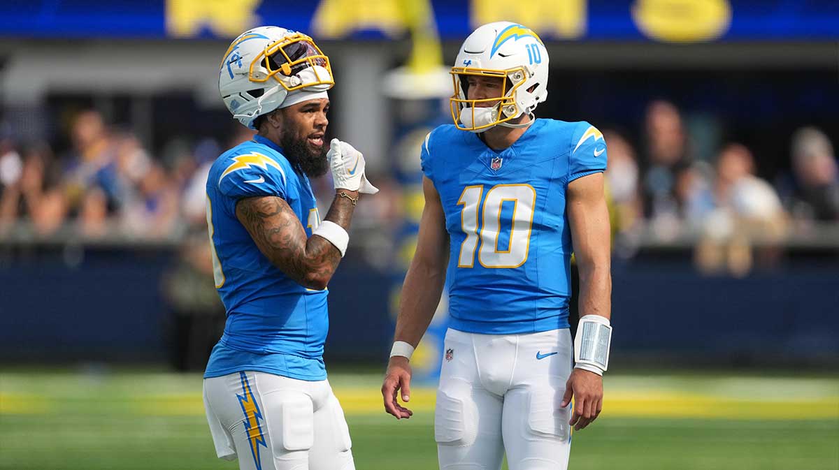 Los Angeles Chargers quarterback Justin Herbert (10) talks with wide receiver Keenan Allen (13) against the Los Angeles Rams in the first half at SoFi Stadium
