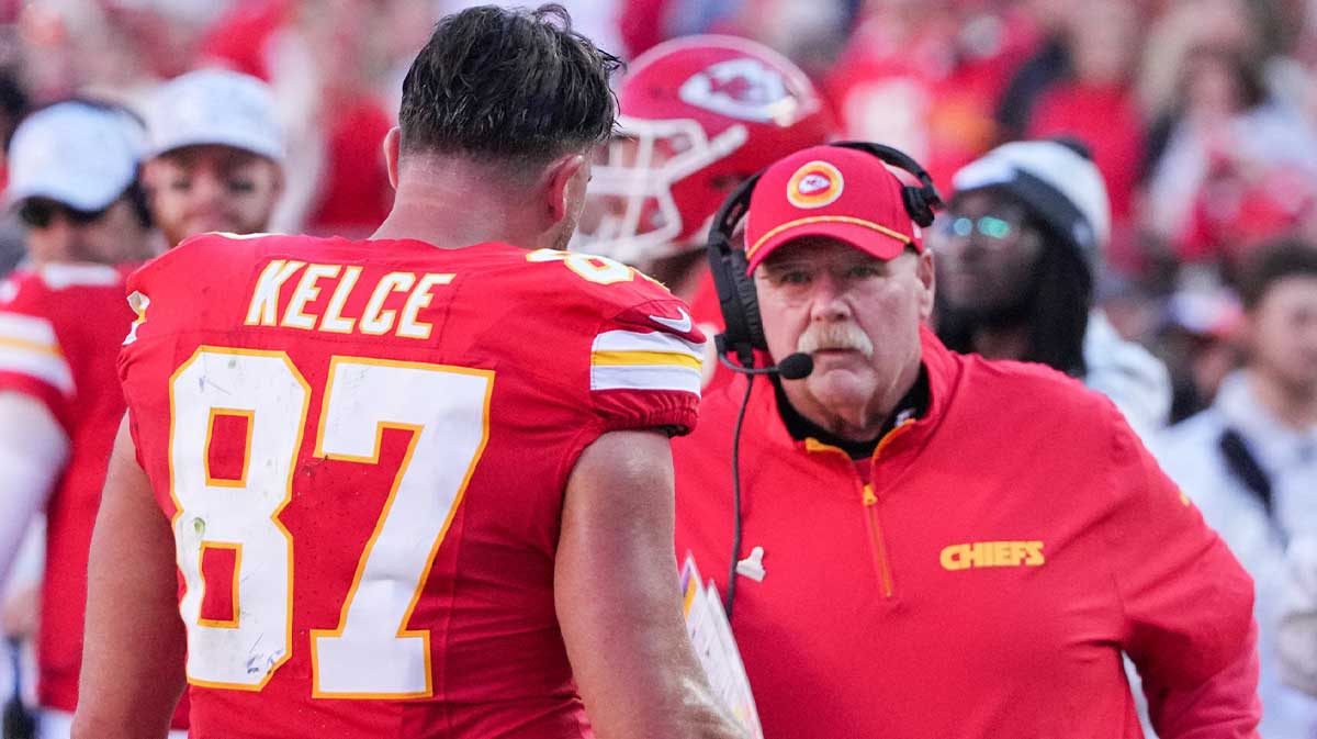 Kansas City Chiefs tight end Travis Kelce (87) talks with head coach Andy Reid against the Denver Broncos during the second half at GEHA Field at Arrowhead Stadium.
