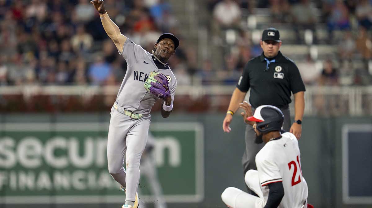 New York Yankees second baseman Jazz Chisholm Jr. (13) forces out Minnesota Twins center fielder Byron Buxton (21) at second base and throws the ball to first base for a double play in the fifth inning at Target Field