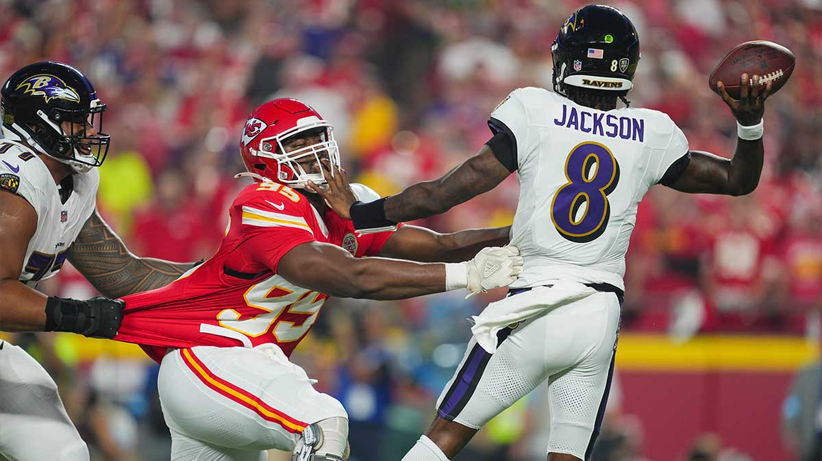 Kansas City Chiefs defensive tackle Chris Jones (95) rushes Baltimore Ravens quarterback Lamar Jackson (8) during the first half at GEHA Field at Arrowhead Stadium.