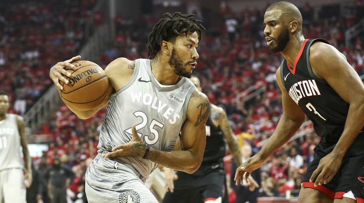 Minnesota Timberwolves guard Derrick Rose (25) dribbles the ball as Houston Rockets guard Chris Paul (3) defends during the second quarter in game two of the first round of the 2018 NBA Playoffs at Toyota Center.