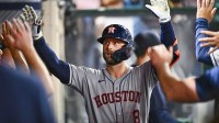 Houston Astros first baseman Christian Walker (8) celebrates with teammates after hitting a solo home run against the Los Angeles Angels during the ninth inning at Angel Stadium.