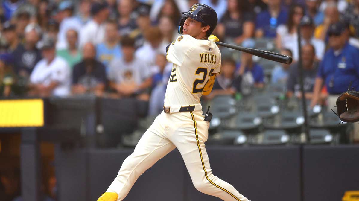 Milwaukee Brewers designated hitter Christian Yelich (22) hits a single during the second inning against the Los Angeles Dodgers at American Family Field.