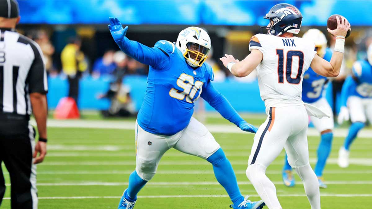 Denver Broncos quarterback Bo Nix (10) makes a pass as Los Angeles Chargers defensive tackle Teair Tart (90)