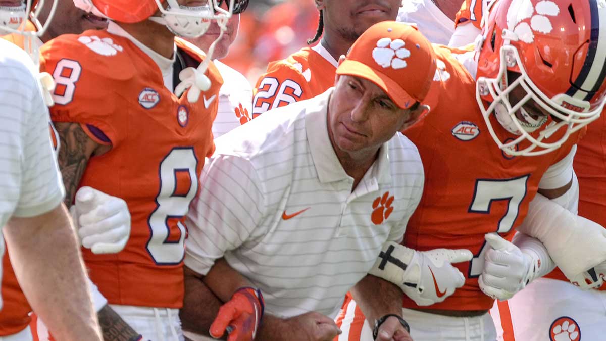 Clemson Tigers head coach Dabo Swinney joins in the Walk of Champions march after pregame practice before their game against the Syracuse Orange in Memorial Stadium.