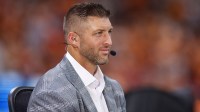 Aug 30, 2025; Atlanta, Georgia, USA; SEC Network analyst Tim Tebow on the field before a game between the Tennessee Volunteers and Syracuse Orange at Mercedes-Benz Stadium. Mandatory Credit: Brett Davis-Imagn Images