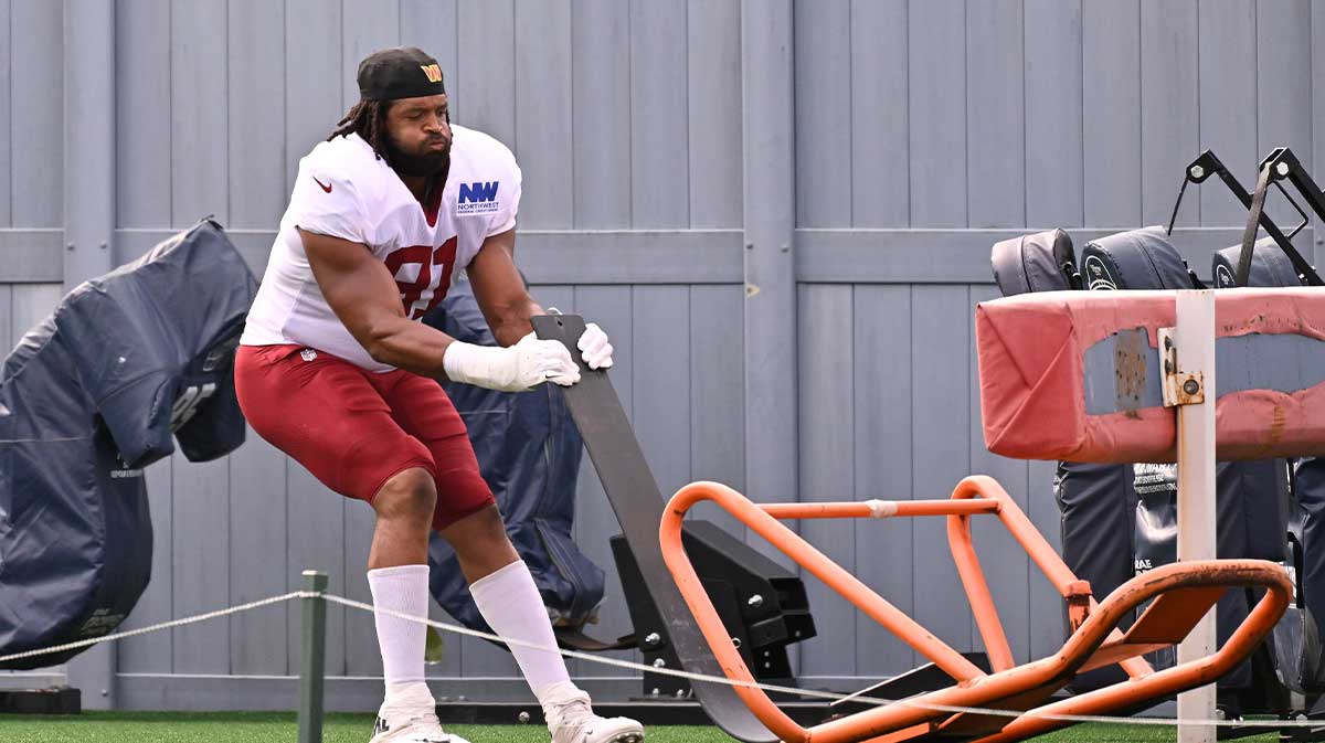 Aug 6, 2025; Foxborough, MA, USA;Washington Commanders defensive end Deatrich Wise Jr. (91) sets up a training aid at training camp at Gillette Stadium. Mandatory Credit: Eric Canha-Imagn Images