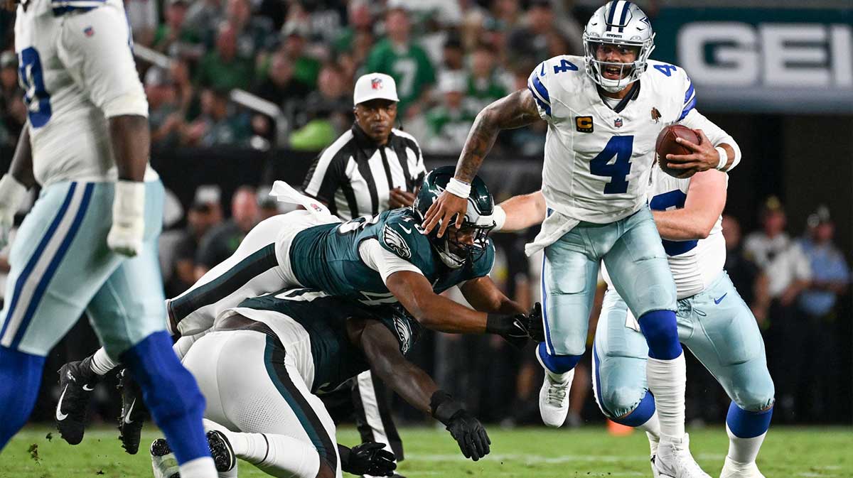 Sep 4, 2025; Philadelphia, Pennsylvania, USA; Dallas Cowboys quarterback Dak Prescott (4) avoids a sack by Philadelphia Eagles defensive tackle Jordan Davis (90) and linebacker Patrick Johnson (48) during the second quarter of the game at Lincoln Financial Field. Mandatory Credit: Eric Hartline-Imagn Images