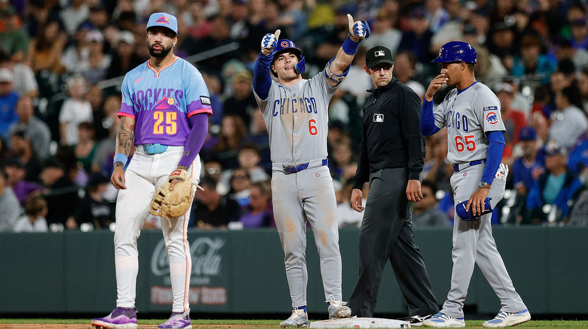 Chicago Cubs third baseman Matt Shaw (6) reacts from first on an RBI single as Colorado Rockies first baseman Warming Bernabel (25) and first base coach Jose Javier (65) look on in the fifth inning at Coors Field.