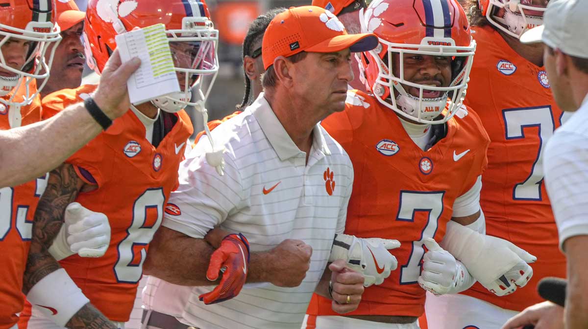 Clemson Tigers head coach Dabo Swinney joins in the Walk of Champions march after pregame practice before their game against the Syracuse Orange in Memorial Stadium.