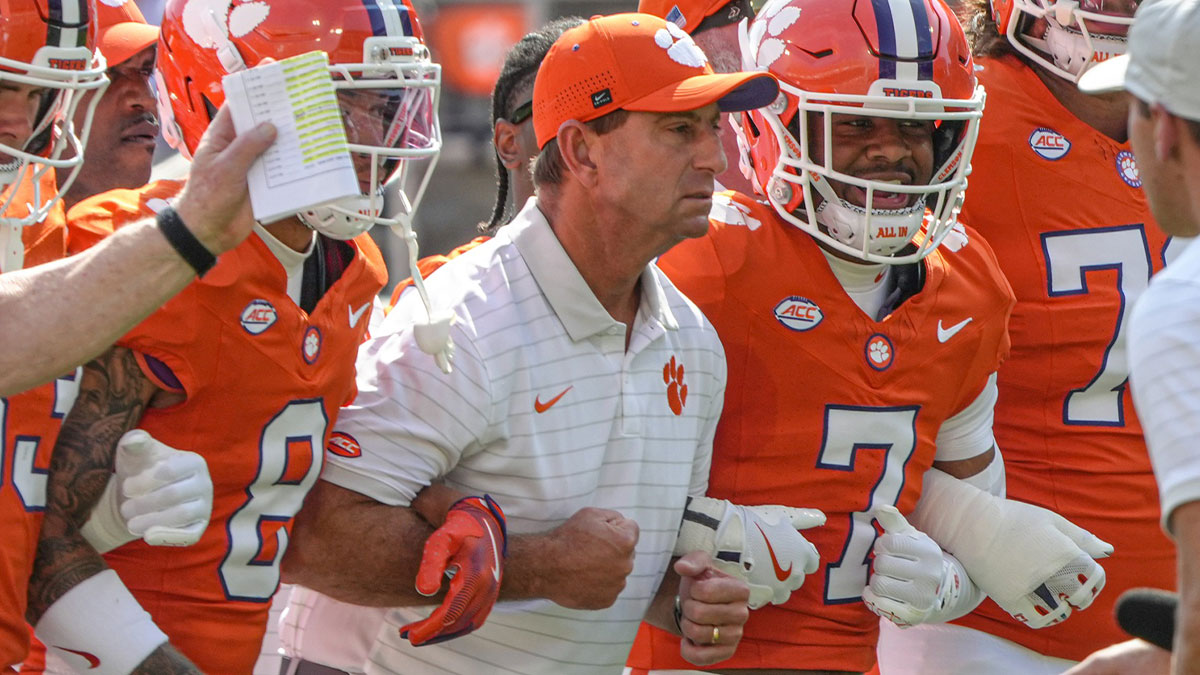 Clemson Tigers head coach Dabo Swinney joins in the Walk of Champions march after pregame practice before their game against the Syracuse Orange in Memorial Stadium.