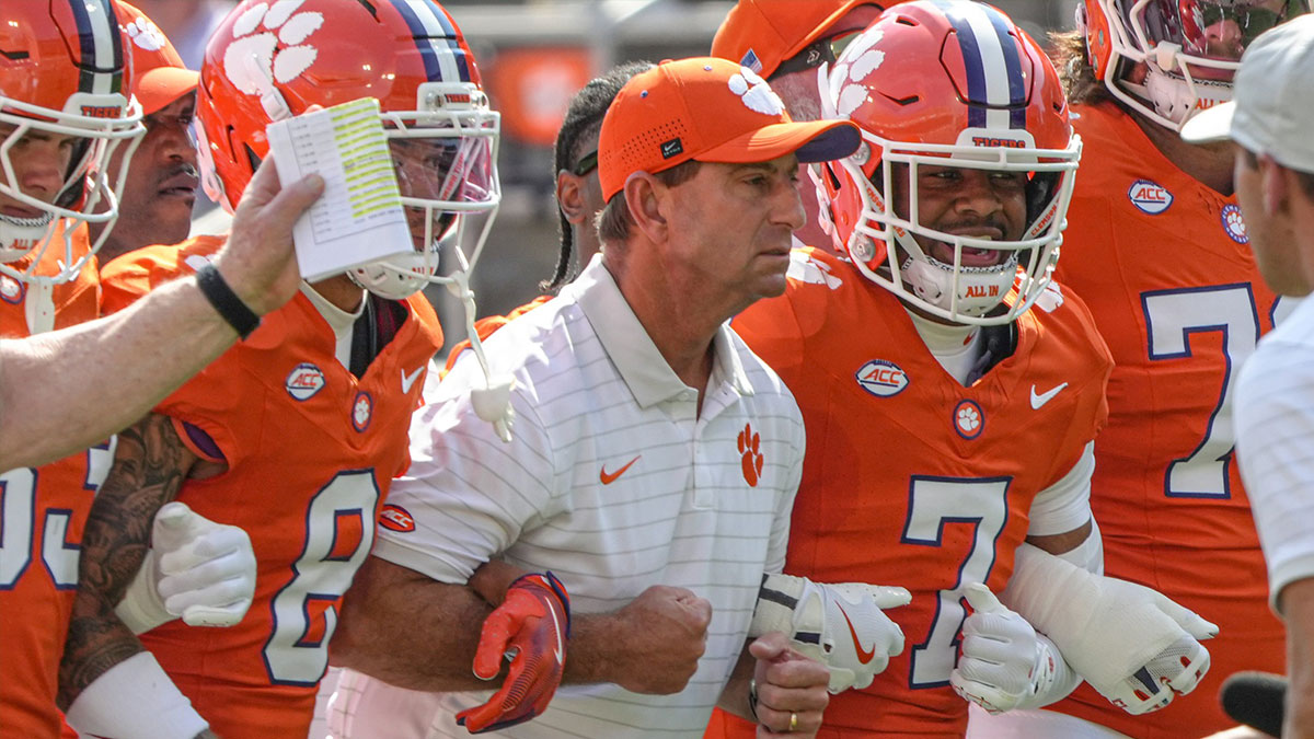 Clemson Tigers head coach Dabo Swinney joins in the Walk of Champions march after pregame practice before their game against the Syracuse Orange in Memorial Stadium.