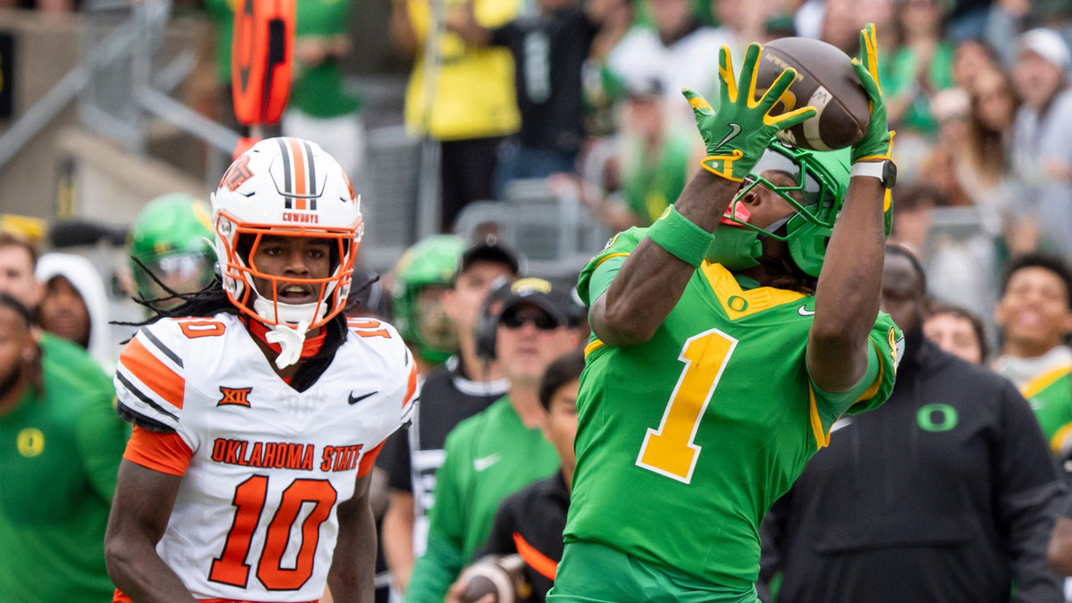 Oregon wide receiver Dakorien Moore hauls in a reception en route to a touchdown under coverage from Oklahoma State cornerback Kale Smith as the Oregon Ducks host the Oklahoma State Cowboys at Autzen Stadium in Eugene, Oregon.