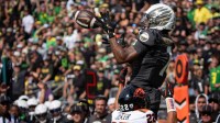 Oregon Ducks wide receiver Dakorien Moore hauls in a touchdown pass under cover from Oregon State Beavers defensive back Jalil Tucker as the Oregon Ducks host the Oregon State Beavers Sept. 20, 2025, at Autzen Stadium in Eugene, Oregon.