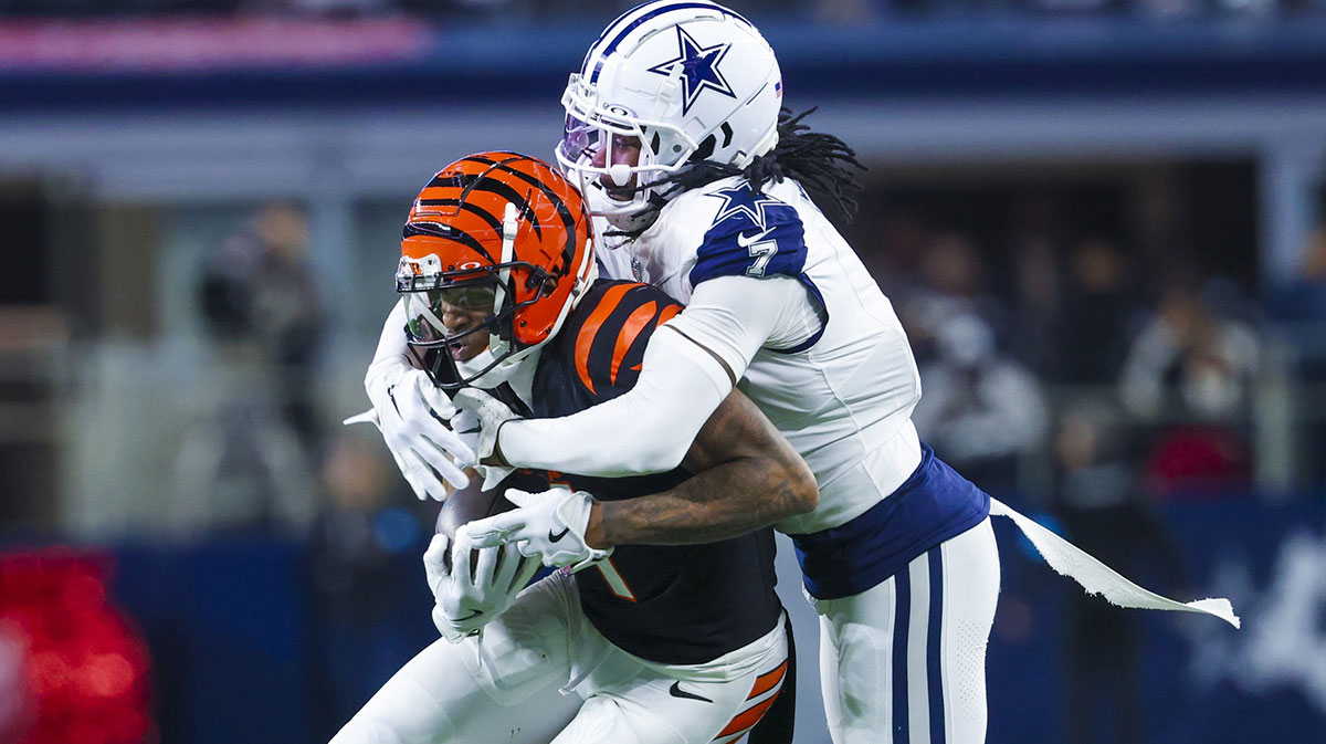 Dallas Cowboys cornerback Trevon Diggs (7) tackles Cincinnati Bengals wide receiver Ja'Marr Chase (1) during the first half at AT&T Stadium.