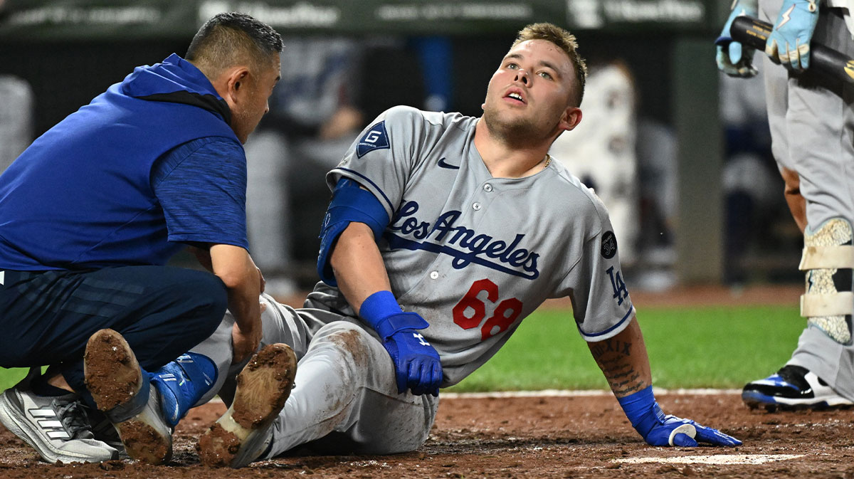 Los Angeles Dodgers catcher Dalton Rushing (68) sits on the ground after a foul ball off his leg during the sixth inning against the Baltimore Orioles at Oriole Park at Camden Yards.