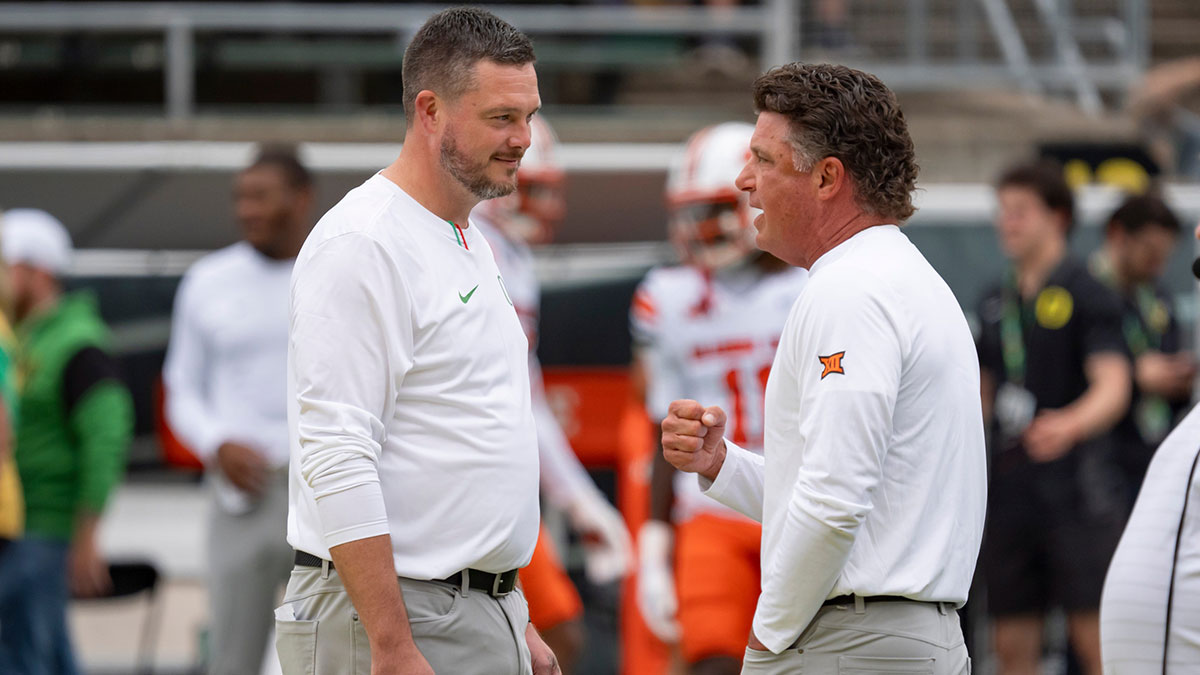 Oregon head coach Dan Lanning, left, and Oklahoma State head coach Mike Gundy talk before the game as the Oregon Ducks host the Oklahoma State Cowboys on Sept. 6, 2025, at Autzen Stadium in Eugene, Oregon.