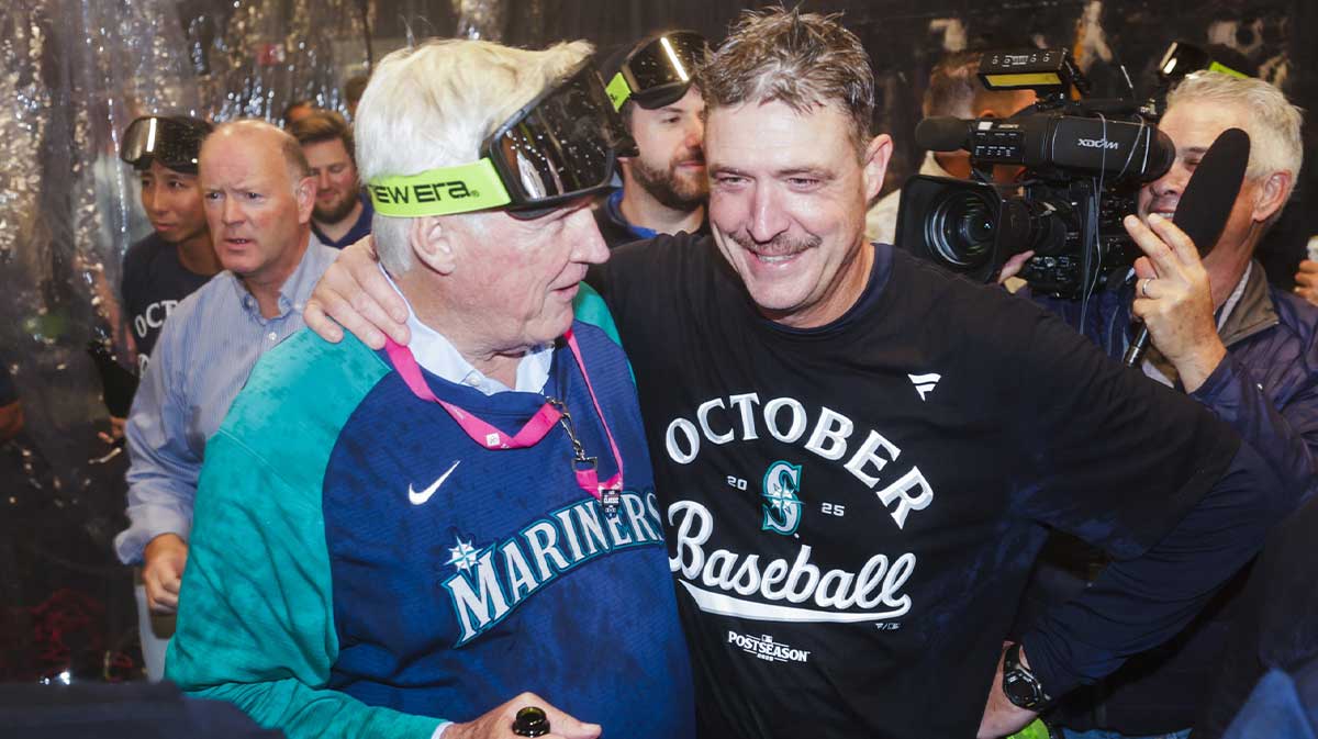Seattle Mariners manager Dan Wilson, right, celebrates with majority owner John Stanton following a playoff-clinching victory against the Colorado Rockies at T-Mobile Park.