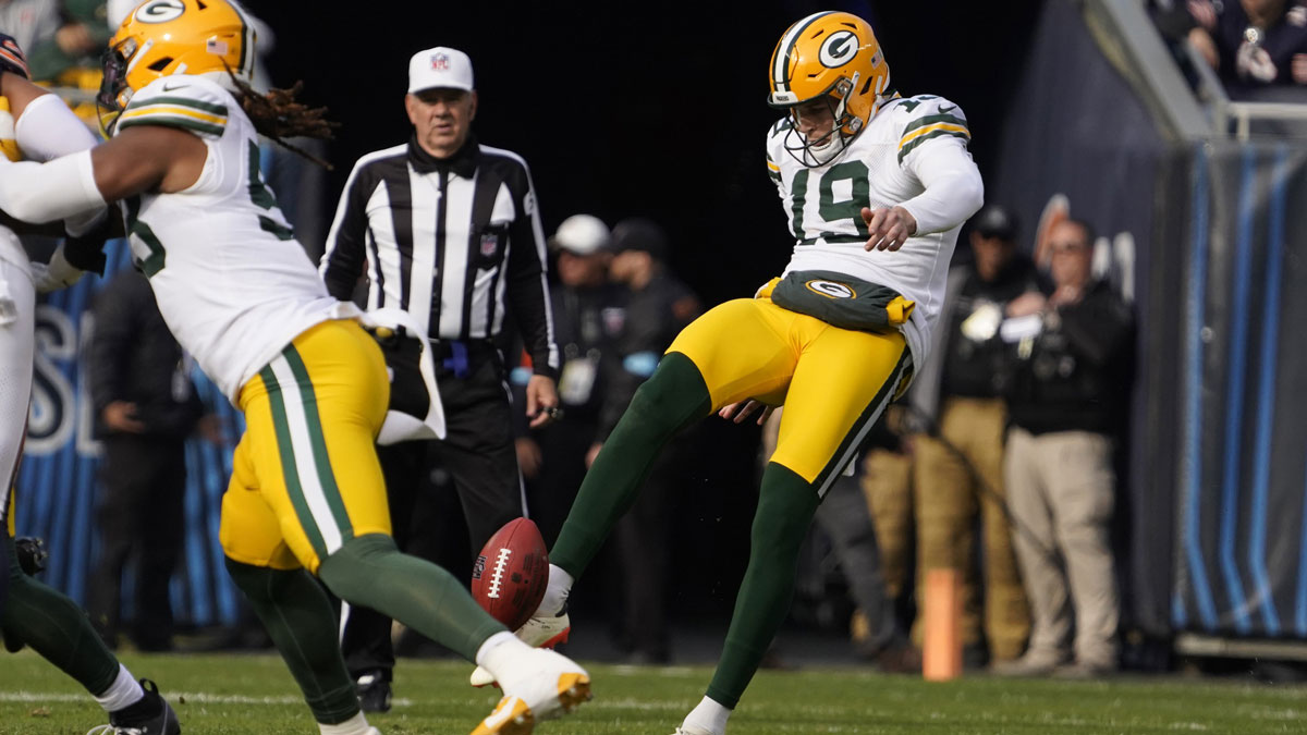 Nov 17, 2024; Chicago, Illinois, USA; Green Bay Packers punter Daniel Whelan (19) punts against the Chicago Bears during the first half at Soldier Field.