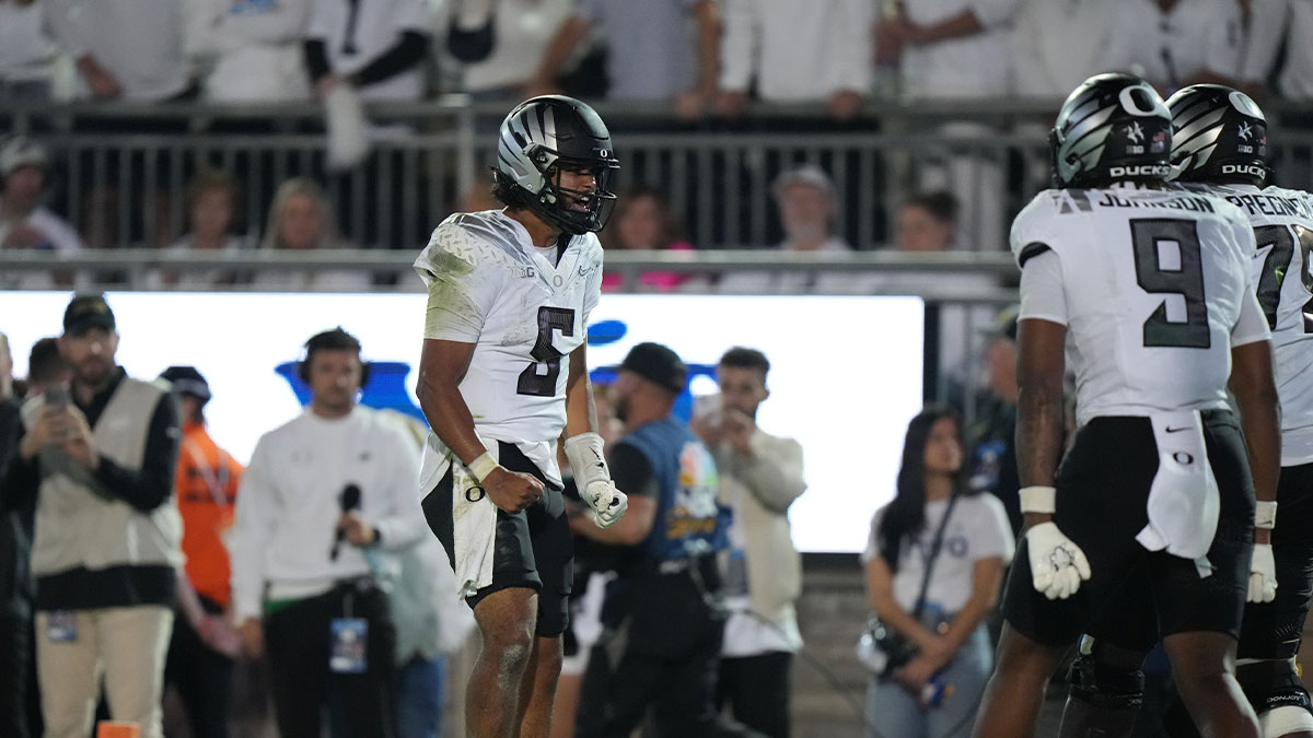 Oregon Ducks quarterback Dante Moore (5) reacts after a touchdown with tight end Jamari Johnson (9) and offensive lineman Emmanuel Pregnon (75) at Beaver Stadium.