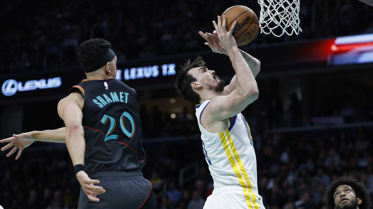 Golden State Warriors forward Dario Saric (20) shoots the ball as Washington Wizards guard Landry Shamet (20) defends in the second half at Capital One Arena.