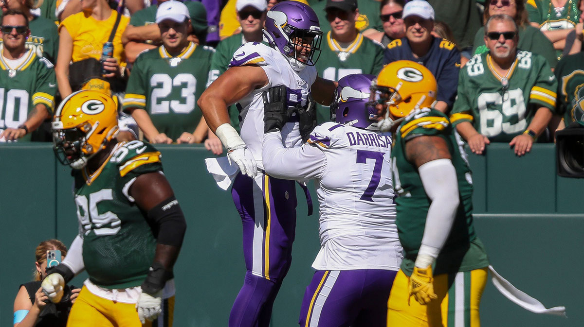 Minnesota Vikings safety Josh Metellus (44) celebrates with offensive tackle Christian Darrisaw (71) after catching a touchdown pass against the Green Bay Packers on Sunday, September 29, 2024, at Lambeau Field in Green Bay, Wis. The Vikings won the game, 31-29.