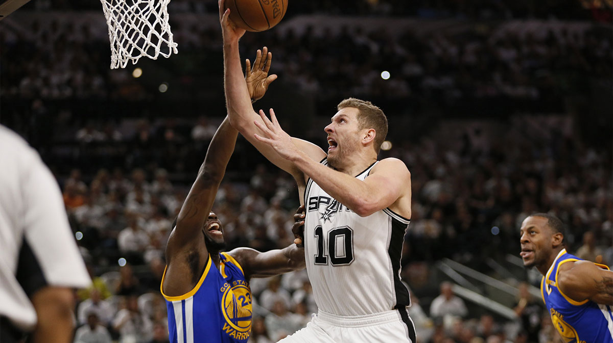 San Antonio Spurs power forward David Lee (10) is fouled while shooting by Golden State Warriors power forward Draymond Green (23) during the first half in game three of the Western conference finals of the NBA Playoffs at AT&T Center.