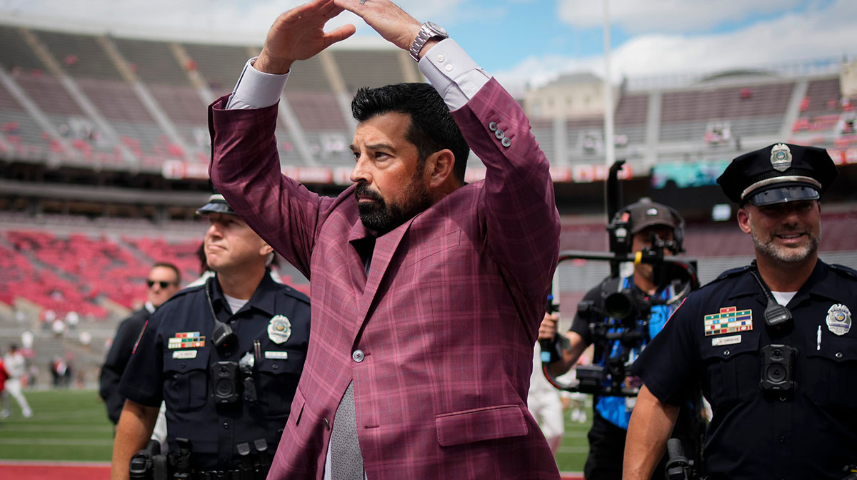 Ohio State Buckeyes head coach Ryan Day gives students an I-O response to their O-H while walking across the field as the team arrives prior to the NCAA football game against the Grambling State Tigers at Ohio Stadium on Sept. 6, 2025.
