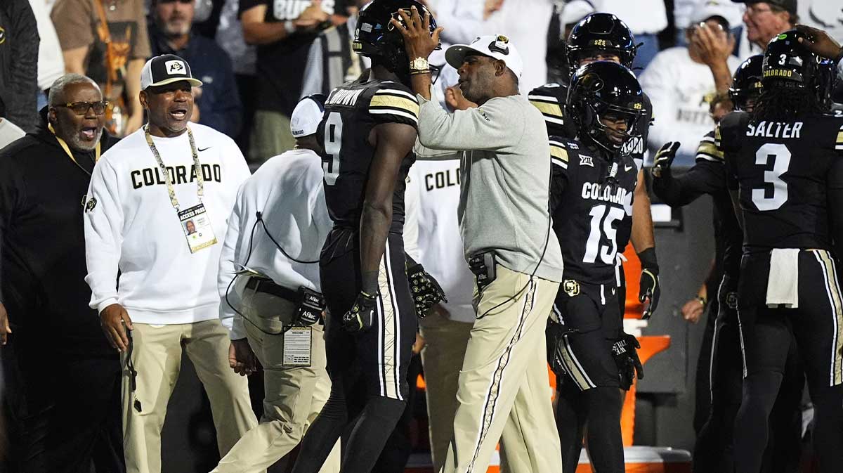 Colorado Buffaloes head coach Deion Sanders congratulates wide receiver Sincere Brown (9 )in second quarter at Folsom Field.
