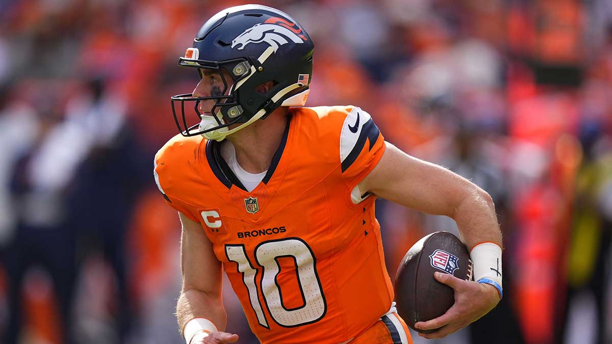 Denver Broncos quarterback Bo Nix (10) rushes the ball against the Tennessee Titans in the second half at Empower Field at Mile High.