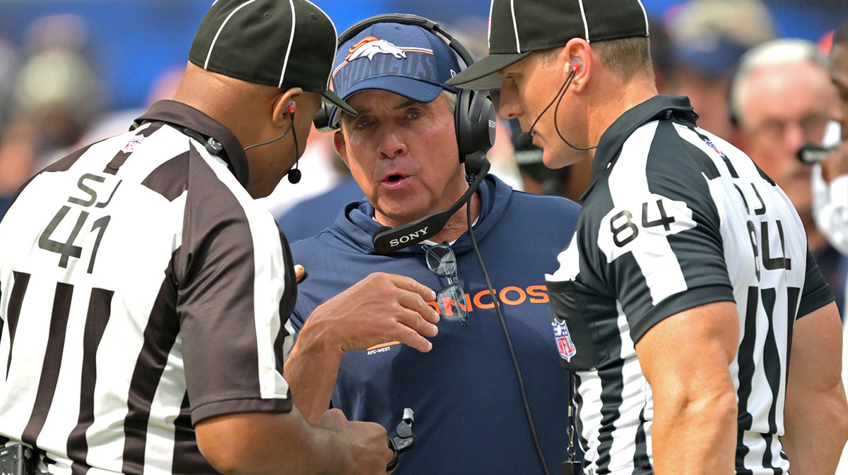Denver Broncos head coach Sean Payton talks with with side judge Boris Cheek (41) and line judge Mark Steinkerchner (84) in the first half against the Los Angeles Chargers at SoFi Stadium.