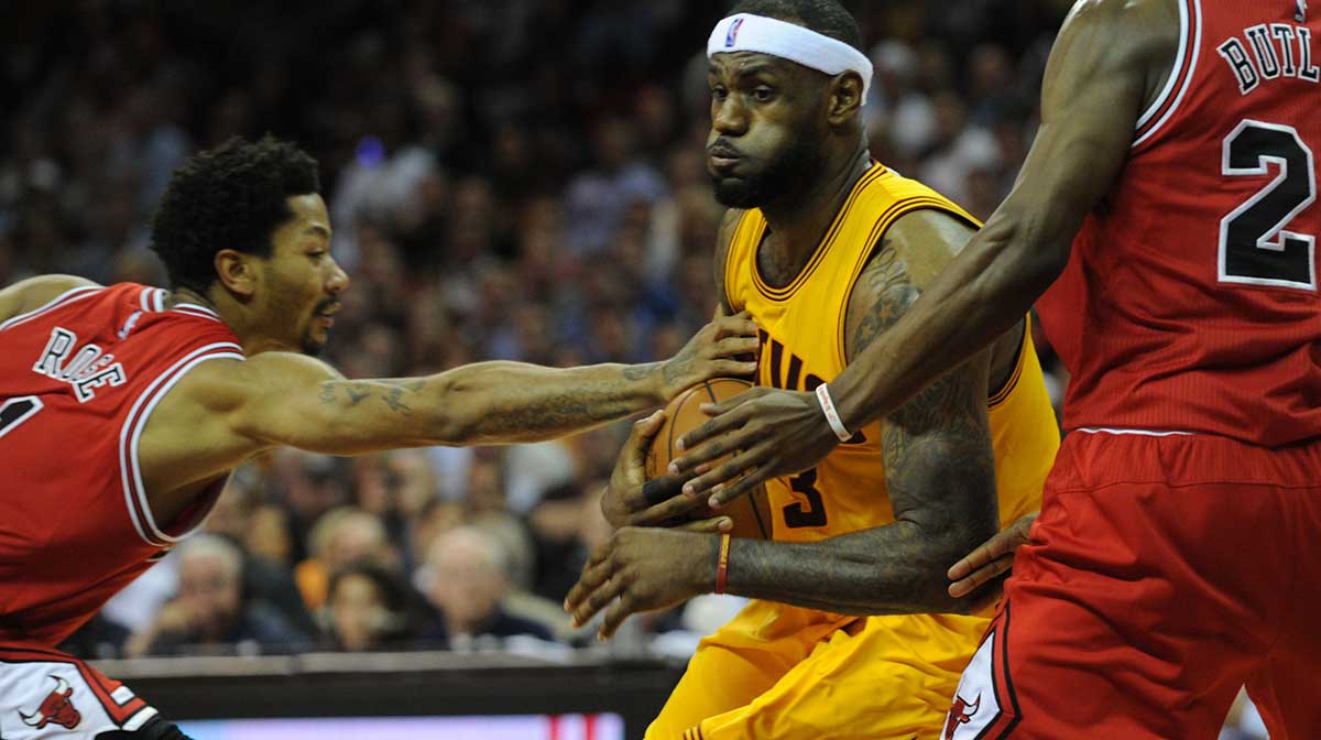 Cleveland Cavaliers forward LeBron James (23) drives through the defense of Chicago Bulls guard Derrick Rose (1) and guard Jimmy Butler (21) during the fourth quarter in game two of the second round of the NBA Playoffs at Quicken Loans Arena.