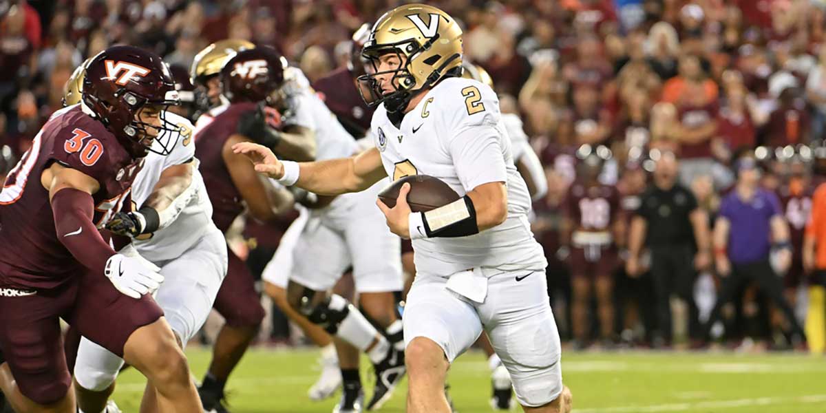 Vanderbilt Commodores quarterback Diego Pavia (2) runs the ball as Virginia Tech Hokies linebacker Michael Short (30) pursues during the first quarter at Lane Stadium.