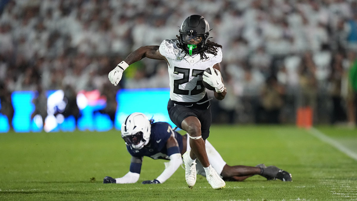 Oregon Ducks running back Dierre Hill Jr. (23) runs for a gain after breaking a tackle by Penn State Nittany Lions cornerback Zion Tracy (7) during the third quarter at Beaver Stadium.