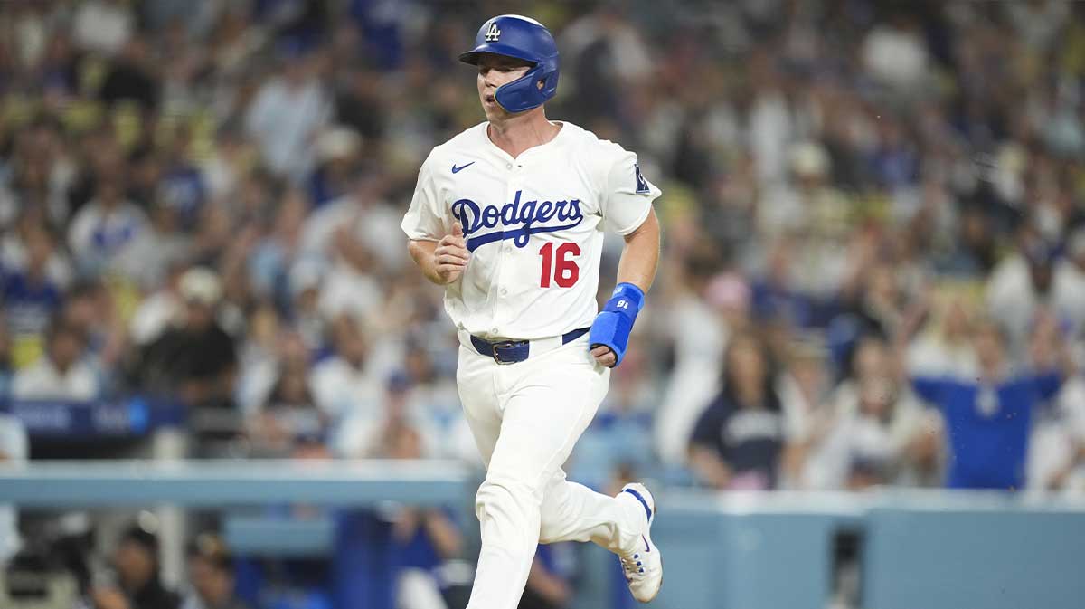 Los Angeles Dodgers catcher Will Smith (16) scores on a wild pitch against the Colorado Rockies during the second inning of the game at Dodger Stadium.