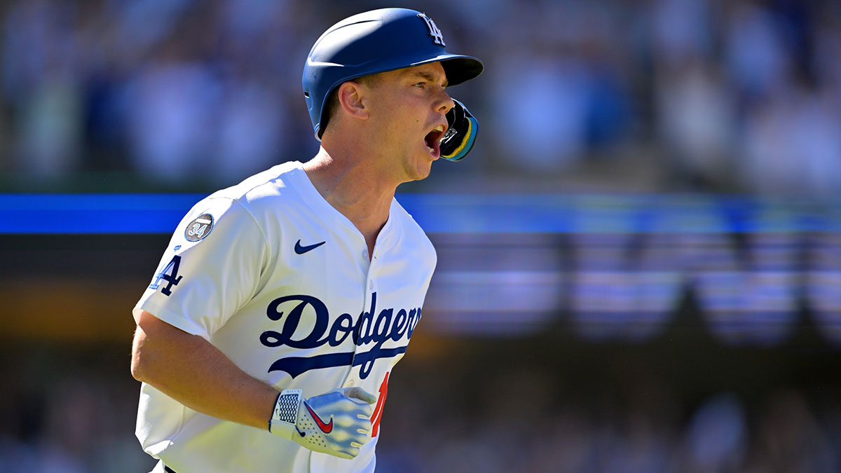 Dodgers catcher Will Smith (16) celebrates as he rounds the bases on a walk-off home run in the ninth inning against the Arizona Diamondbacks at Dodger Stadium with an injury update in the background
