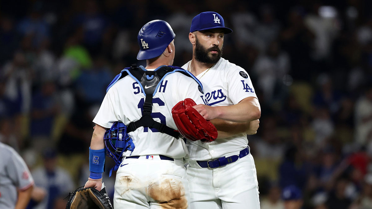Dodgers relief pitcher Tanner Scott (66) and catcher Will Smith (16) celebrate a win after defeating the Cincinnati Reds 6-3 at Dodger Stadium