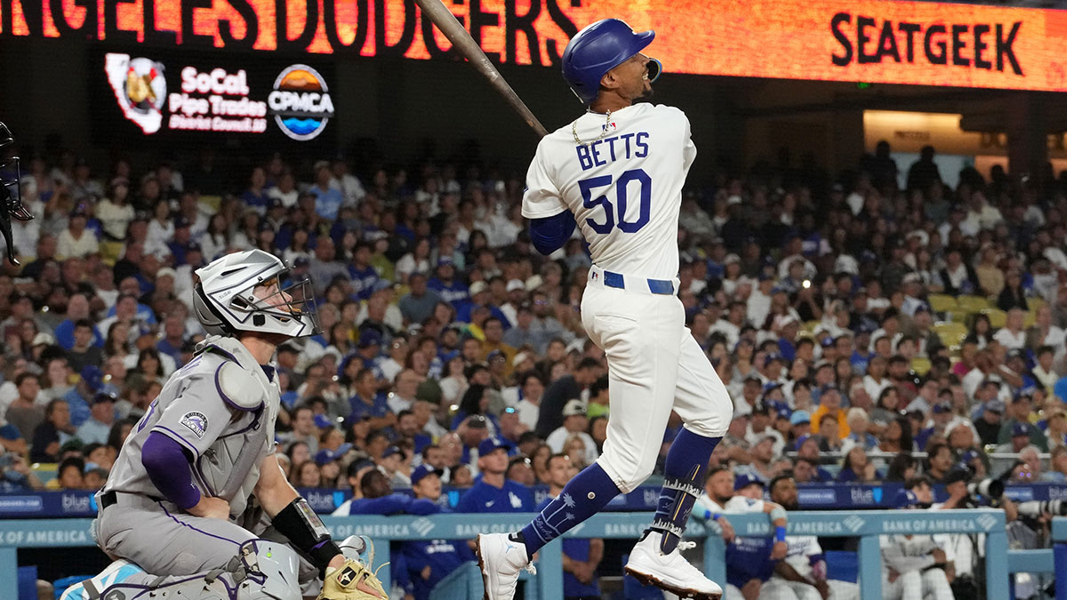 Los Angeles Dodgers shortstop Mookie Betts (50) bats as Colorado Rockies catcher Hunter Goodman (15) watches at Dodger Stadium.