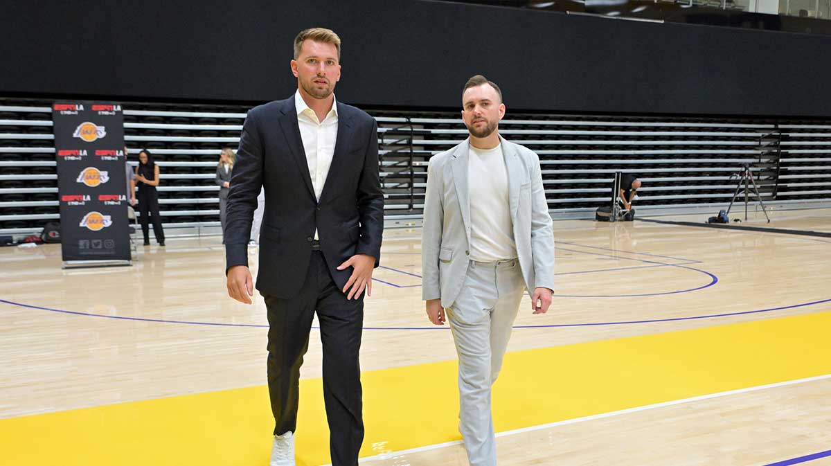 Los Angeles Lakers Luka Doncic (77) walks with team communications director Mitch Heckart following a press conference announcing the signing of a 3-year, $165 million contract extension at UCLA Health Training Center