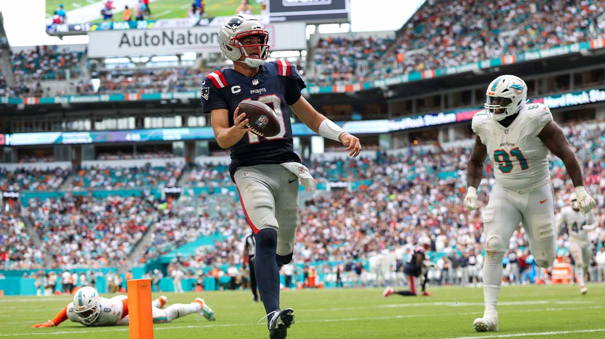 New England Patriots quarterback Drake Maye (10) runs into the endzone for a touchdown against the Miami Dolphins in the third quarter at Hard Rock Stadium.