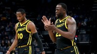 Golden State Warriors forward Jonathan Kuminga (00) and Golden State Warriors forward Draymond Green (23) walk to the bench at the end of the first quarter against the Memphis Grizzlies at FedExForum.