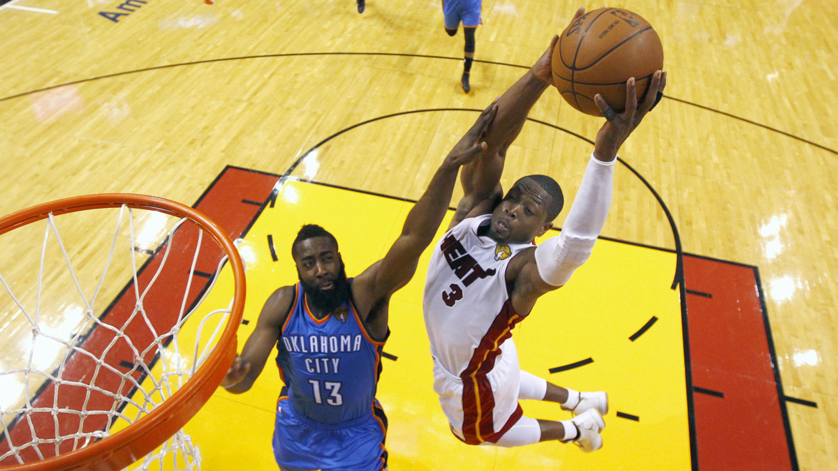 Miami Heat shooting guard Dwyane Wade (3) dunks the ball past Oklahoma City Thunder guard James Harden (13) during the second half of game three in the 2012 NBA Finals at the American Airlines Arena. The Heat defeated the Thunder 91-85.