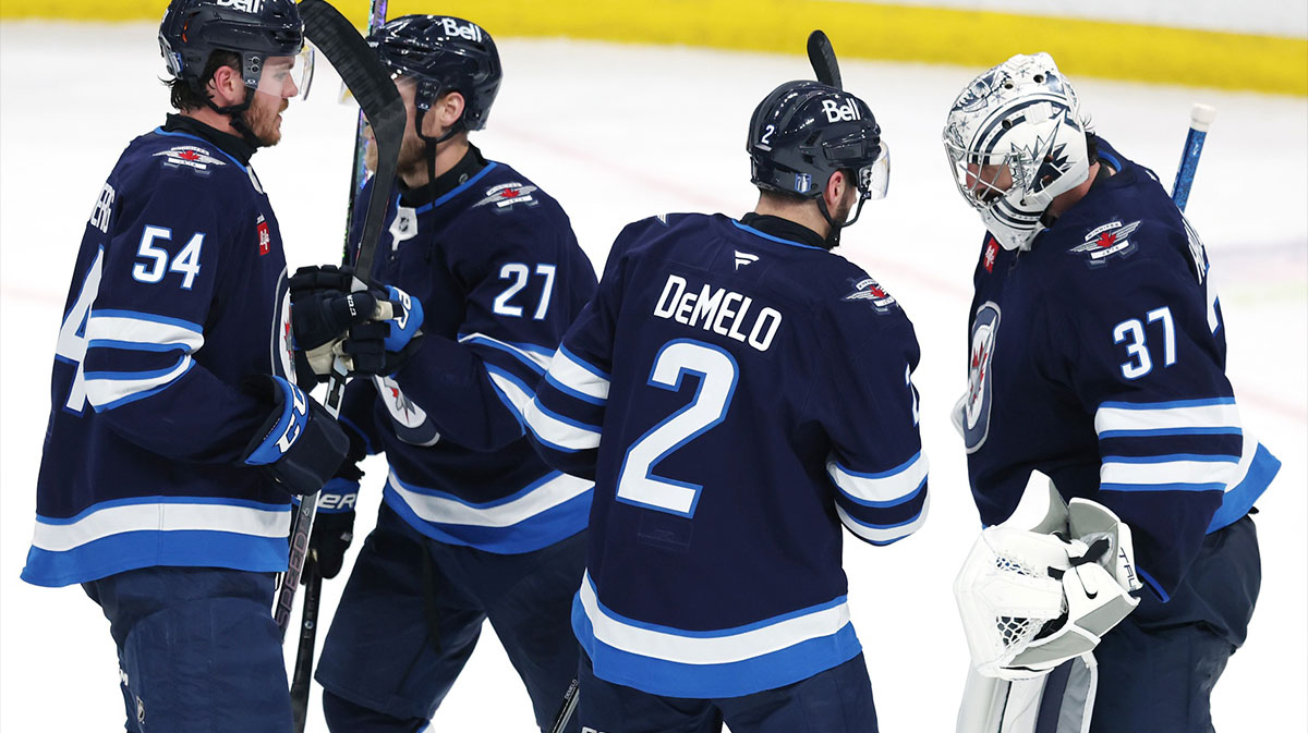 Winnipeg Jets defenseman Dylan Samberg (54), Winnipeg Jets left wing Nikolaj Ehlers (27), Winnipeg Jets defenseman Dylan DeMelo (2) and Winnipeg Jets goaltender Connor Hellebuyck (37) celebrate their victory over the Dallas Stars in game two of the second round of the 2025 Stanley Cup Playoffs at Canada Life Centre