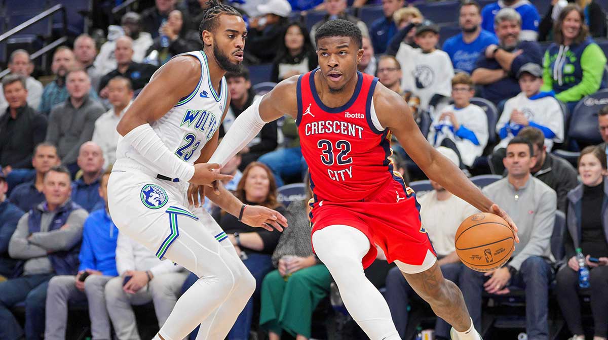Nov 8, 2023; Minneapolis, Minnesota, USA; New Orleans Pelicans forward E.J. Liddell (32) dribbles against the Minnesota Timberwolves forward Troy Brown Jr. (23) in the fourth quarter at Target Center. Mandatory Credit: Brad Rempel-Imagn Images