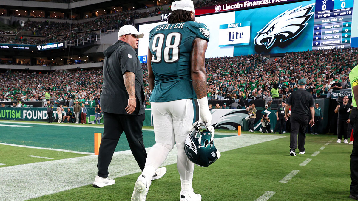 Philadelphia Eagles defensive tackle Jalen Carter (98) walks off the field with Eagles chief security officer Dom DiSandro (L) after being ejected from the game against the Dallas Cowboys at Lincoln Financial Field.