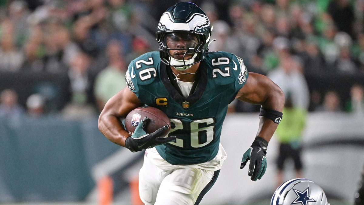 Philadelphia Eagles running back Saquon Barkley (26) runs past Dallas Cowboys cornerback DaRon Bland (26) at Lincoln Financial Field.