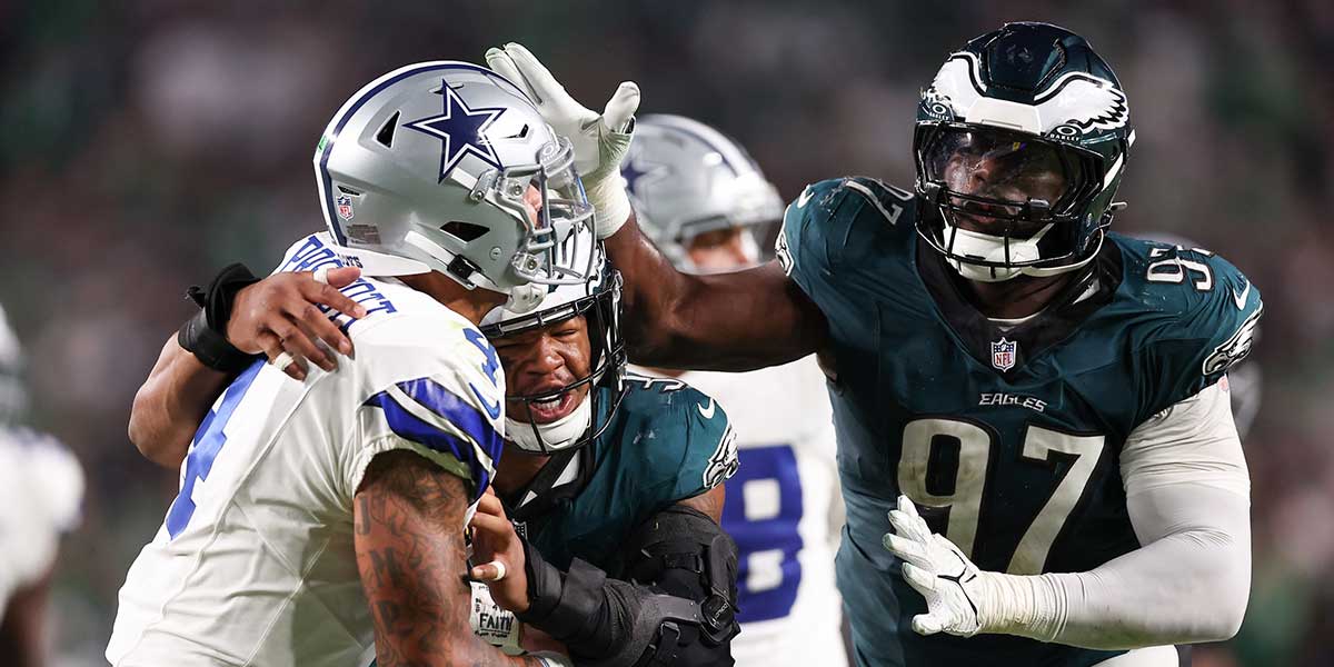 Sep 4, 2025; Philadelphia, Pennsylvania, USA; Philadelphia Eagles place kicker Jake Elliott (4) is hit by Philadelphia Eagles linebacker Nolan Smith Jr. (3) and defensive tackle Moro Ojomo (97) after a pass during the fourth quarter of the game at Lincoln Financial Field